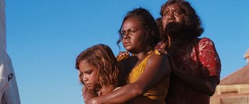 Movie still from “Australia” (2008), directed by Baz Luhrmann – A group of people standing next to each other on top of a hill; Close Up shot, Low angle