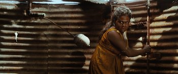 Movie still from “Australia” (2008), directed by Baz Luhrmann – An older woman standing in front of an old building; Medium shot, High angle