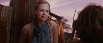 Movie still from “Australia” (2008), directed by Baz Luhrmann – A woman in a blue shirt and a brown sweater; Close Up shot, Over the shoulder angle