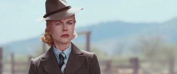 Movie still from “Australia” (2008), directed by Baz Luhrmann – A woman wearing a hat and a suit and tie; Close Up shot, Low angle