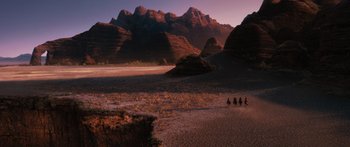 Movie still from “Australia” (2008), directed by Baz Luhrmann – A group of people riding horses through a desert; Extreme Wide shot, High angle