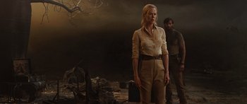 Movie still from “Australia” (2008), directed by Baz Luhrmann – A woman standing next to a man in a dark room; Medium shot, Over the shoulder angle