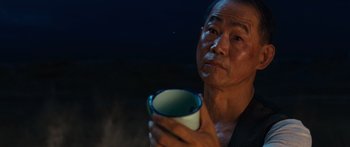 Movie still from “Australia” (2008), directed by Baz Luhrmann – An older man holding a coffee cup in his hands; Close Up shot, Over the shoulder angle