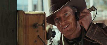 Movie still from “Australia” (2008), directed by Baz Luhrmann – A man in a cowboy hat looking into a camera; Close Up shot, Low angle