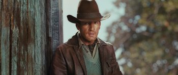 Movie still from “Australia” (2008), directed by Baz Luhrmann – A man wearing a brown hat and a brown jacket; Close Up shot, Over the shoulder angle