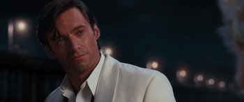 Movie still from “Australia” (2008), directed by Baz Luhrmann – A man in a white suit and a tie; Close Up shot, Over the shoulder angle