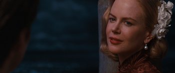 Movie still from “Australia” (2008), directed by Baz Luhrmann – A woman's face in a dark room; Close Up shot, Over the shoulder angle