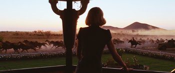Movie still from “Australia” (2008), directed by Baz Luhrmann – A woman standing in front of a window looking at a herd of wild horses; Wide shot, Over the shoulder angle
