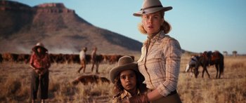 Movie still from “Australia” (2008), directed by Baz Luhrmann – A woman and a child in a field with cows; Medium shot, Over the shoulder angle