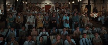 Movie still from “Australia” (2008), directed by Baz Luhrmann – A large group of people sitting in a room; Wide shot, High angle