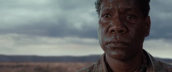Movie still from “Australia” (2008), directed by Baz Luhrmann – A man's face in front of a cloudy sky; Close Up shot, Low angle