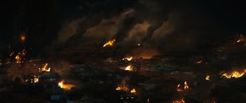 Movie still from “Australia” (2008), directed by Baz Luhrmann – A fire is burning in the sky over a city at night; Extreme Wide shot, High angle