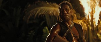 Movie still from “Australia” (2008), directed by Baz Luhrmann – A man with a beard and a leather vest is posing for a picture; Close Up shot, High angle