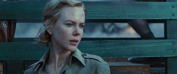 Movie still from “Australia” (2008), directed by Baz Luhrmann – A person sitting on a bench; Close Up shot, Over the shoulder angle