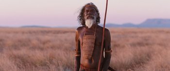 Movie still from “Australia” (2008), directed by Baz Luhrmann – An old man with a long white beard holding a spear; Medium shot, Low angle