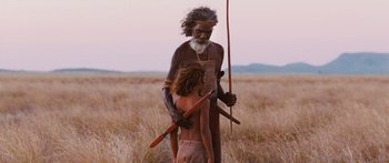 Movie still from “Australia” (2008), directed by Baz Luhrmann – An older man and a young boy in a field; Medium shot, Over the shoulder angle