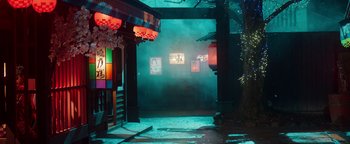 Movie still from “Prisoners of the Ghostland” (2021), directed by Sion Sono – A street scene of a street with fog coming from the ground; Extreme Wide shot, High angle
