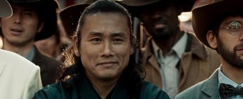 Movie still from “Prisoners of the Ghostland” (2021), directed by Sion Sono – A person wearing a robe; Close Up shot, Low angle