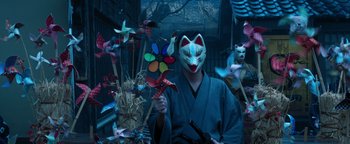 Movie still from “Prisoners of the Ghostland” (2021), directed by Sion Sono – A person wearing a mask and holding a sword; Medium shot, Low angle
