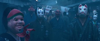 Movie still from “Prisoners of the Ghostland” (2021), directed by Sion Sono – A group of people wearing masks in the dark; Close Up shot, Low angle