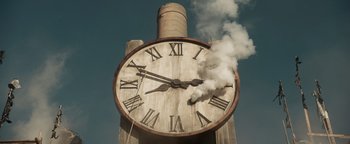 Movie still from “Prisoners of the Ghostland” (2021), directed by Sion Sono – A large clock with steam coming out of it's face; Extreme Wide shot, Low angle