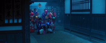 Movie still from “Prisoners of the Ghostland” (2021), directed by Sion Sono – A group of women in traditional japanese garb with balloons; Wide shot, Low angle
