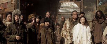 Movie still from “Prisoners of the Ghostland” (2021), directed by Sion Sono – A group of people standing next to each other; Medium shot, Low angle
