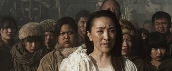 Movie still from “Prisoners of the Ghostland” (2021), directed by Sion Sono – A group of people that are standing in a room; Close Up shot, High angle