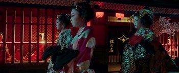 Movie still from “Prisoners of the Ghostland” (2021), directed by Sion Sono – Two geishas are standing in front of a building; Medium shot, Low angle