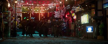 Movie still from “Prisoners of the Ghostland” (2021), directed by Sion Sono – A group of men in black robes holding swords; Extreme Wide shot, Low angle