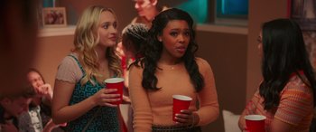 Movie still from “Prom Pact” (2023), directed by Anya Adams – A woman holding two cups in her hands; Close Up shot, Over the shoulder angle
