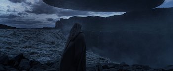 Movie still from “Prometheus” (2012), directed by Ridley Scott – A person standing in front of a waterfall at night; Extreme Wide shot, Low angle