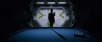 Movie still from “Prometheus” (2012), directed by Ridley Scott – A man standing in a room next to a window; Wide shot, Over the shoulder angle