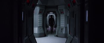 Movie still from “Prometheus” (2012), directed by Ridley Scott – A man standing inside of a spaceship looking into a room; Wide shot, Low angle