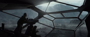 Movie still from “Prometheus” (2012), directed by Ridley Scott – A view from inside an airplane looking out at a mountain landscape; Wide shot, High angle
