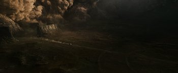 Movie still from “Prometheus” (2012), directed by Ridley Scott – A car driving on a dirt road near a mountain; Extreme Wide shot, High angle