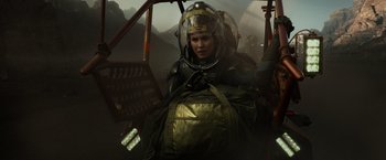 Movie still from “Prometheus” (2012), directed by Ridley Scott – A woman in a helmet is sitting in an airplane; Medium shot, Low angle