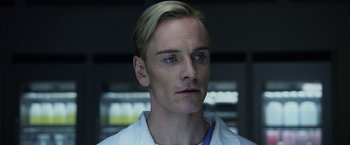 Movie still from “Prometheus” (2012), directed by Ridley Scott – A person wearing a lab coat; Close Up shot, Low angle