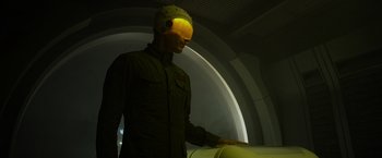 Movie still from “Prometheus” (2012), directed by Ridley Scott – A man with a helmet on his head is standing in a tunnel; Medium shot, Over the shoulder angle