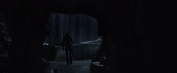 Movie still from “Prometheus” (2012), directed by Ridley Scott – A man standing in the dark in front of trees; Wide shot, Low angle