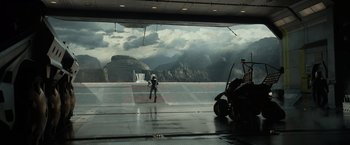 Movie still from “Prometheus” (2012), directed by Ridley Scott – A person standing on a ramp in front of a mountain view; Extreme Wide shot, High angle