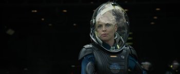 Movie still from “Prometheus” (2012), directed by Ridley Scott – A woman wearing a space suit and a helmet; Close Up shot, Over the shoulder angle