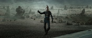 Movie still from “Prometheus” (2012), directed by Ridley Scott – A man in a space suit standing in a field of rocks; Wide shot, High angle