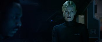 Movie still from “Prometheus” (2012), directed by Ridley Scott – A woman in a black shirt is in the dark; Close Up shot, Low angle
