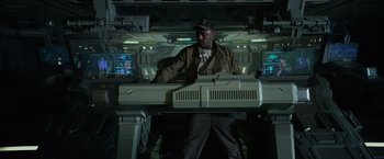 Movie still from “Prometheus” (2012), directed by Ridley Scott – A man standing in front of an electronic device; Medium shot, High angle