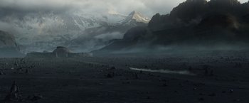 Movie still from “Prometheus” (2012), directed by Ridley Scott – A car driving on a dirt road near a mountain range; Extreme Wide shot, High angle