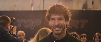 Movie still from “Code Name Emperor” (2022), directed by Jorge Coira – A person with curly red hair; Close Up shot, Low angle