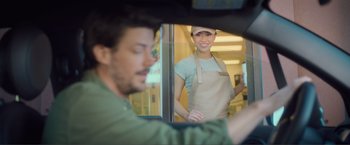 Movie still from “Puppy Love” (2023), directed by Richard Alan Reid – A man and a woman are standing in front of a window; Medium shot, Over the shoulder angle