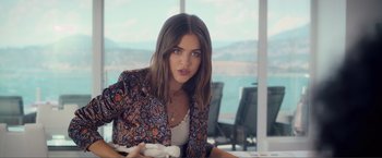 Movie still from “Puppy Love” (2023), directed by Richard Alan Reid – A beautiful young lady sitting in front of a window; Medium shot, Over the shoulder angle