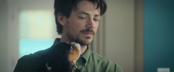 Movie still from “Puppy Love” (2023), directed by Richard Alan Reid – A person with a dog; Close Up shot, Over the shoulder angle